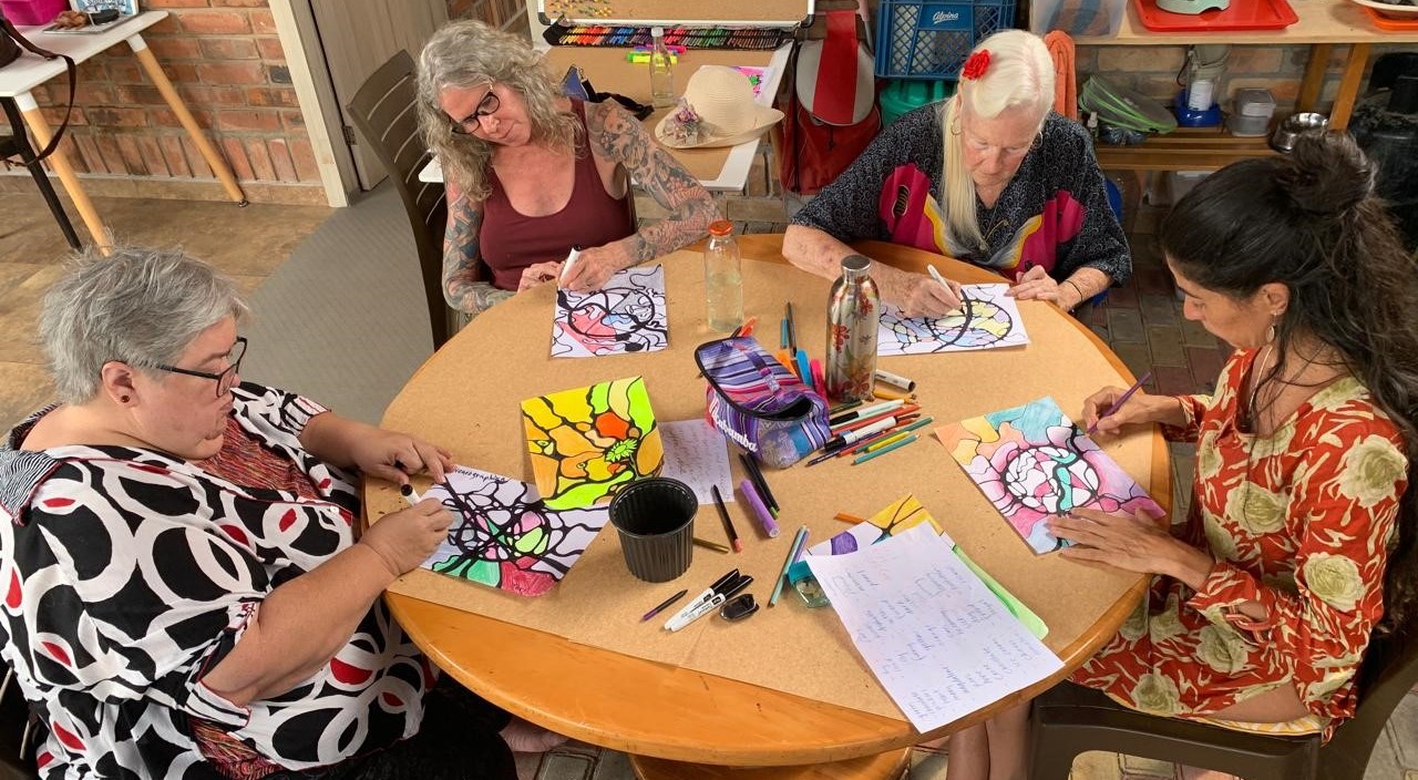 Participants in a Microdose Neuro Art class working on coloring pages